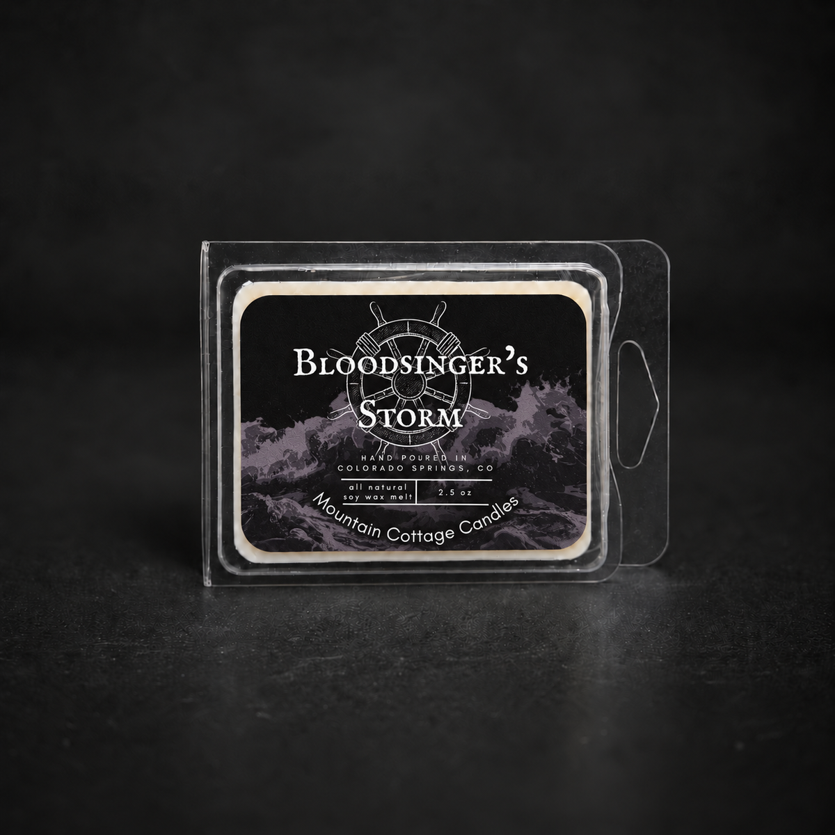 Bloodsinger's Storm soy wax melt in a clear clamshell pack, black label with a ship's wheel above stormy waves