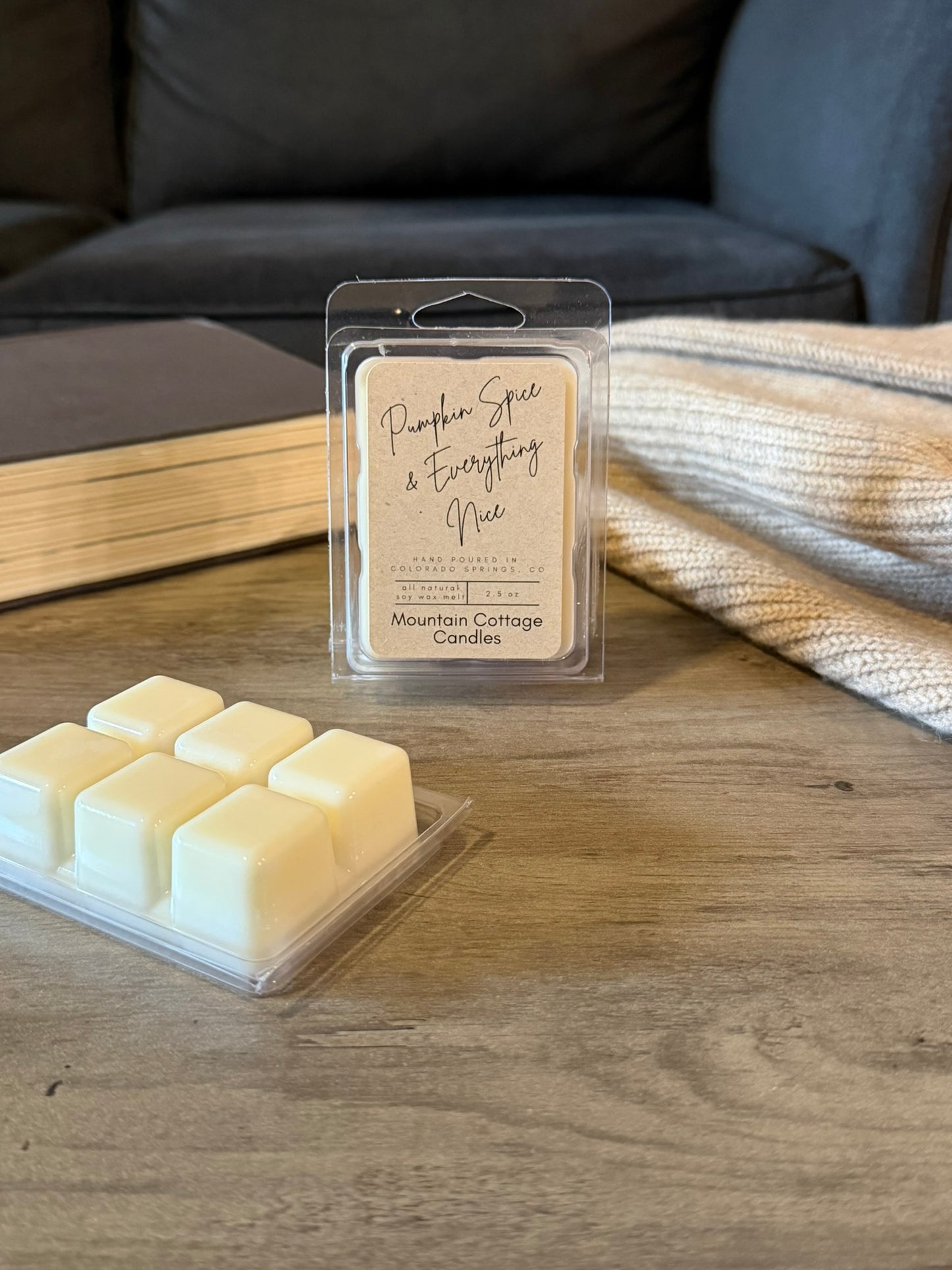Pumpkin Spice & Everything Nice soy wax melt in a kraft-labeled clamshell, six cream wax cubes laid out in front on a wood table