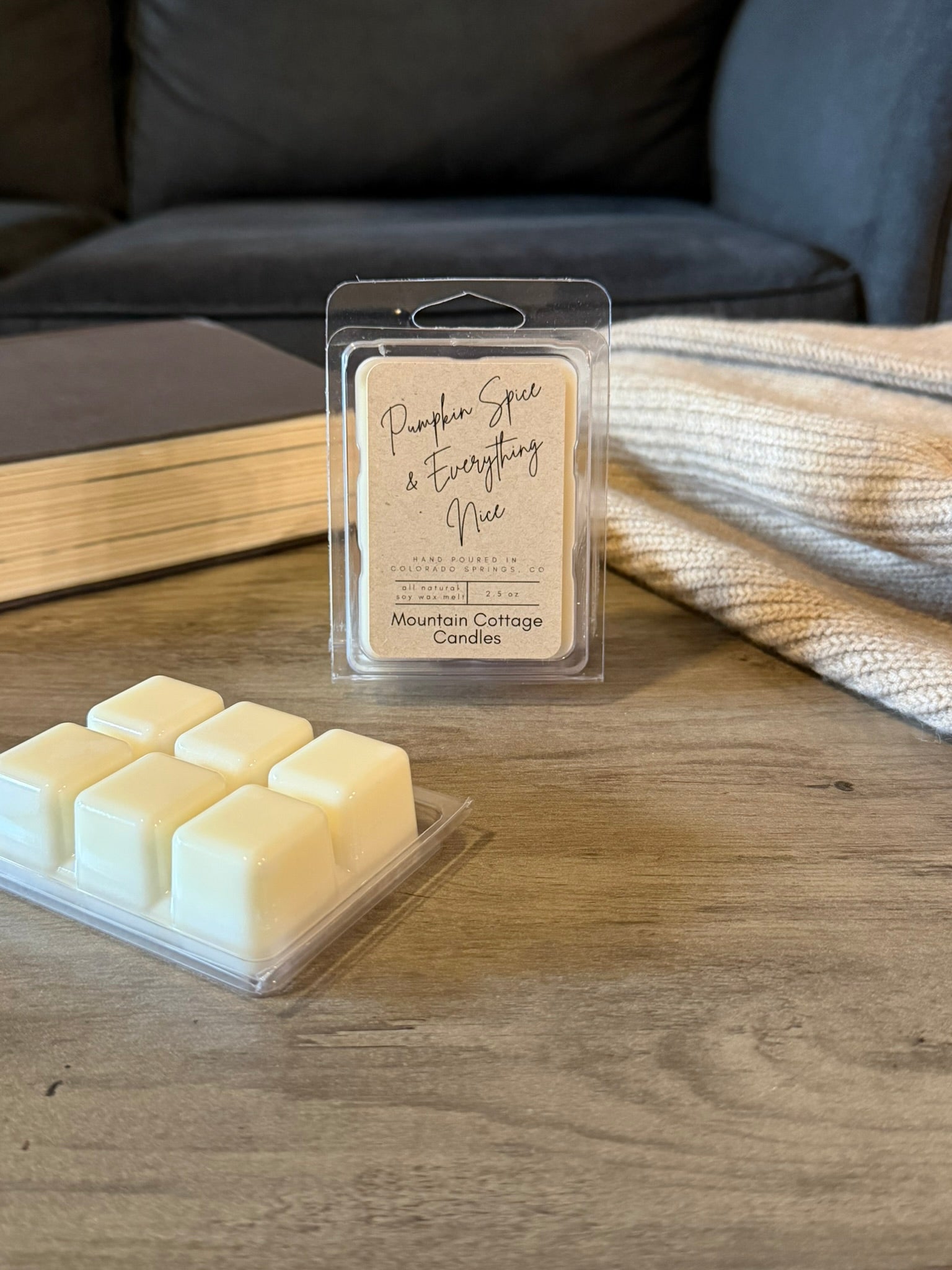 Pumpkin Spice & Everything Nice soy wax melt in a kraft-labeled clamshell, six cream wax cubes laid out in front on a wood table
