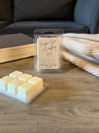 Pumpkin Spice & Everything Nice soy wax melt in a kraft-labeled clamshell, six cream wax cubes laid out in front on a wood table