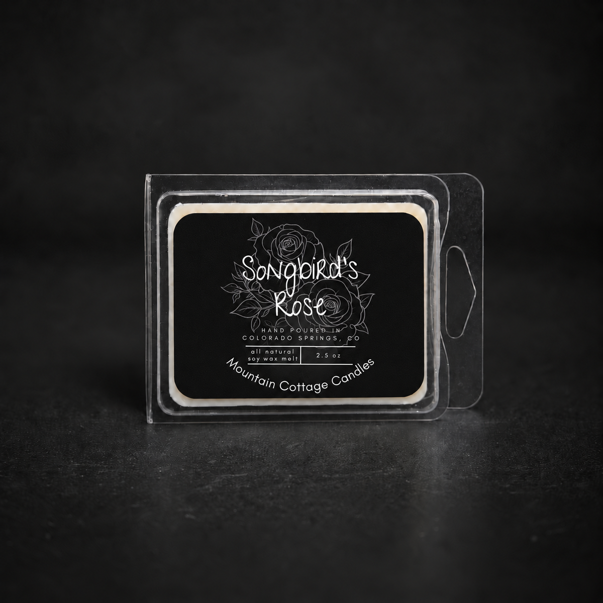 Songbird's Rose soy wax melt in a clear clamshell pack, black label with line-drawn roses and leaves