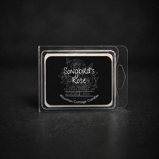 Songbird's Rose soy wax melt in a clear clamshell pack, black label with line-drawn roses and leaves
