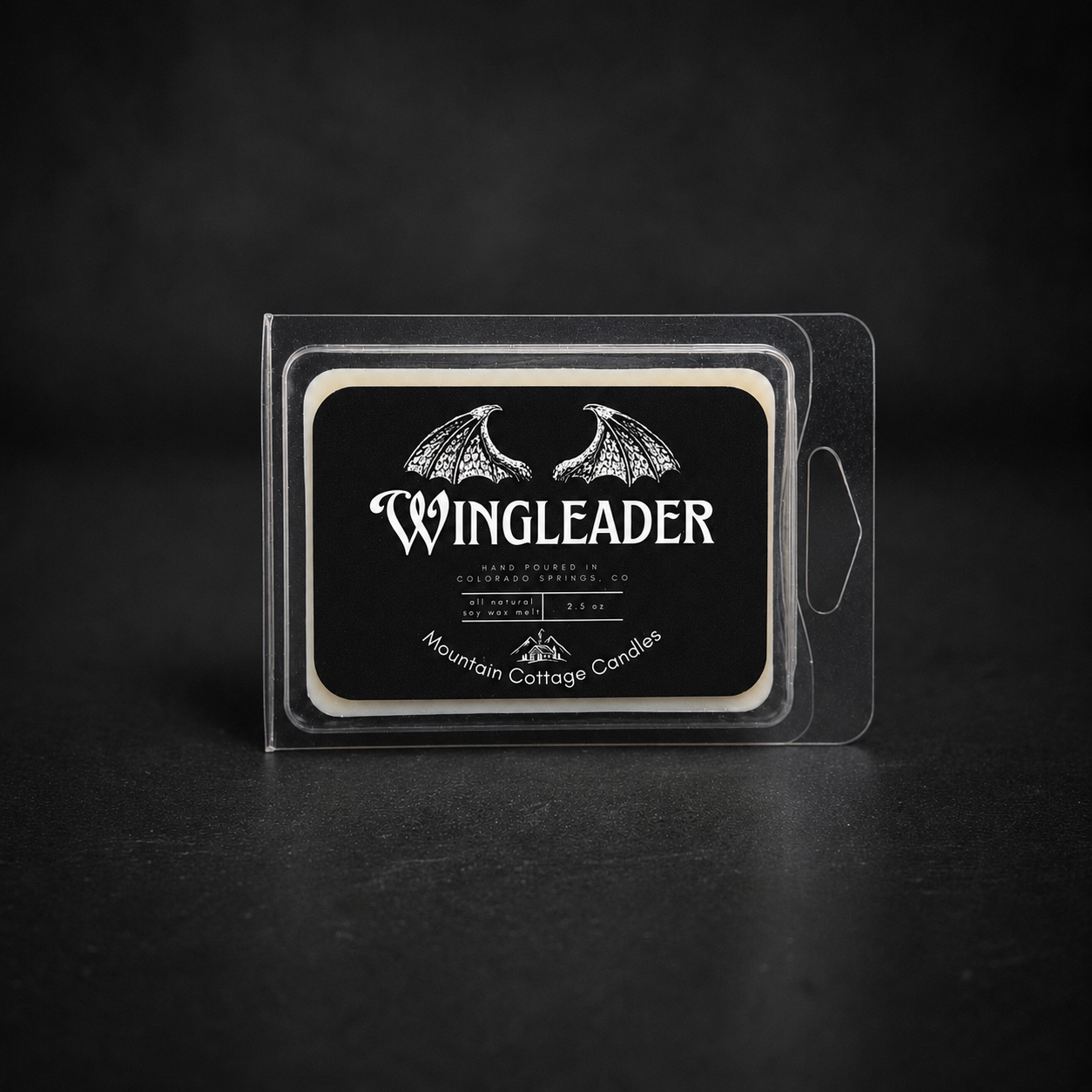 Wingleader soy wax melt in a clear clamshell pack, black label showing a pair of outspread dragon wings